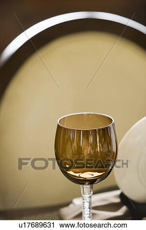 Stock Image - Detail of Brown Wine Glass on Dining Table. Fotosearch