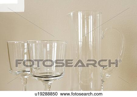 Detail of glass pitcher with two wine glasses View Large Photo Image Stock Image - Detail of glass pitcher with two wine glasses. Fotosearch