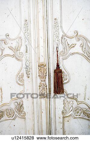 Stock Photo - Detail of tassels on ornate armoire. Fotosearch