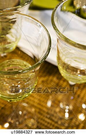 Stock Photo - Green Crystal Glasses on Woven/Wicker Tray. Fotosearch
