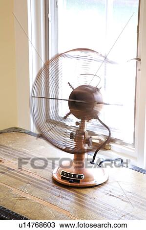 Stock Image - Old fashioned brass fan. Fotosearch