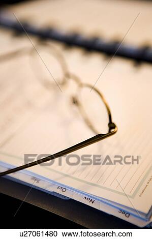 Stock Image - Reading Glasses on Daily Planner/Calendar. Fotosearch