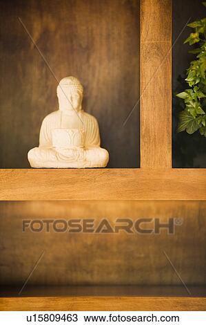 Statue of Buddha on shelf View Large Photo Image Stock Image - Statue of Buddha on shelf. Fotosearch