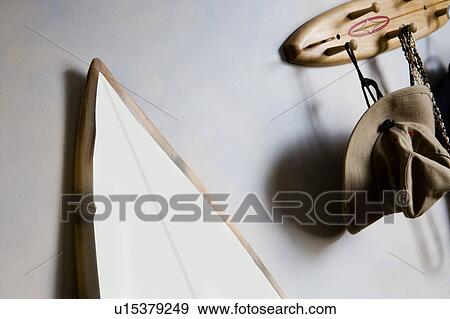 White and blue surf board with wood trim leaning against white wall near entry way. View Large Photo Image Stock Photo - White and blue surf board with wood trim leaning against white wall near entry way.. Fotosearch
