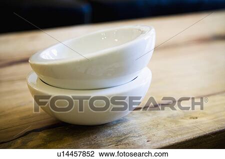 Stock Image - White Bowl on Wood Table. Fotosearch