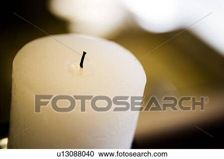 Stock Image - White Pillar Candle without a Flame. Fotosearch