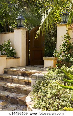 Stock Photo - Front Gate and Steps to Spanish Style Home. Fotosearch