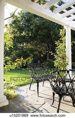Stock Photo - Outdoor Patio With Wrought Iron Dining Set. Fotosearch
