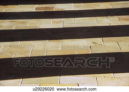 Stock Image - Shadows on Stone Tile Floor. Fotosearch
