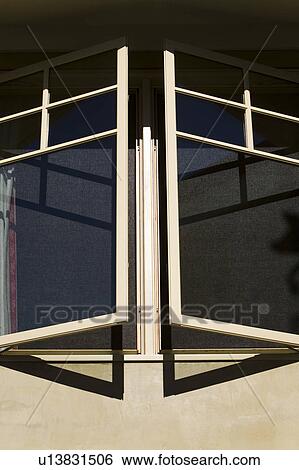 Stock Photograph - Exterior Shot of Open Windows on Contemporary Home. Fotosearch