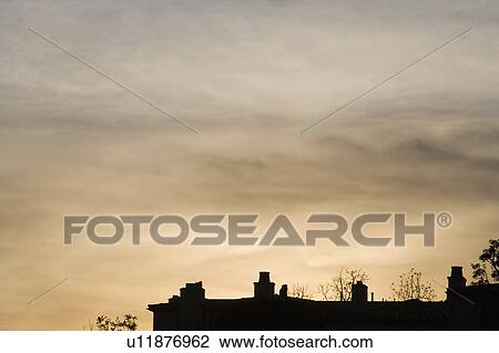 Stock Image - Silhouette of Rooftop at Sunset. Fotosearch