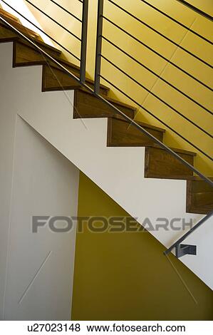 Stock Photo - Detail of Modern Hardwood Stairwell and Yellow Wall. Fotosearch