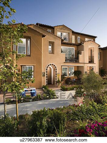Exterior of attached home during the evening View Large Photo Image Stock Photo - Exterior of attached home during the evening. Fotosearch