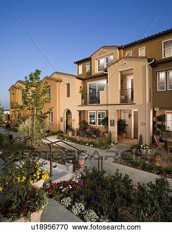 Exterior of attached homes during the evening View Large Photo Image Stock Image - Exterior of attached homes during the evening. Fotosearch