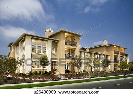 Exterior of attached homes on a sunny day View Large Photo Image Stock Photo - Exterior of attached homes on a sunny day. Fotosearch