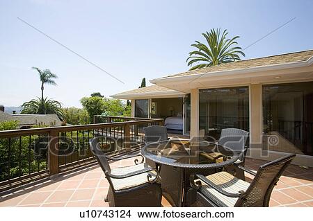 Picture - Exterior of back patio with dining table. Fotosearch