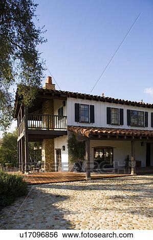 Stock Photograph - Exterior of Spanish Style Home and Landscape. Fotosearch