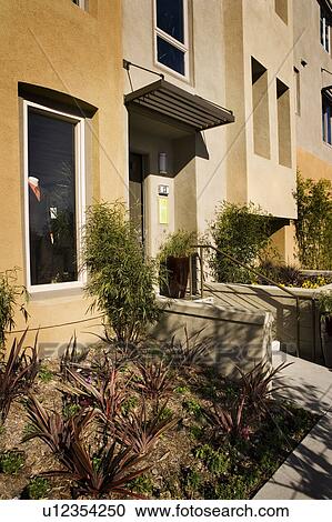 Stock Image - Exterior Shot of Contemporary Yellow Stucco Condominiums/Homes. Fotosearch