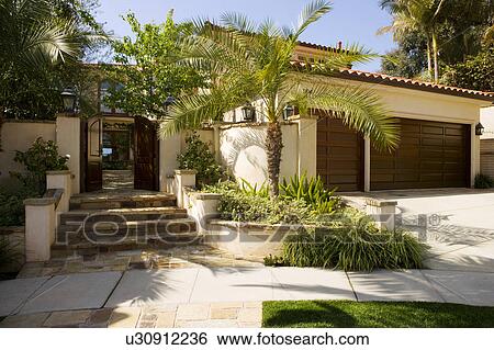Stock Photograph - Front Exterior of Spanish Style Home. Fotosearch