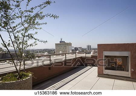 Stock Photograph - Outdoor patio with fireplace and view of city.. Fotosearch