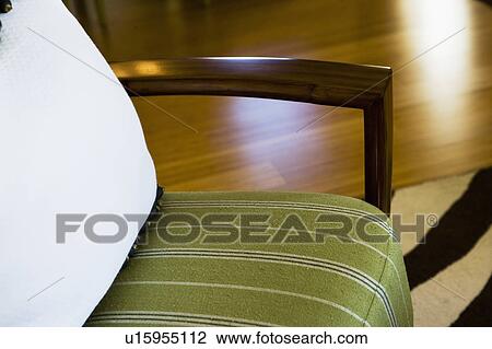 Stock Image - Contemporary Chair with Green Cushion and Wood Arm. Fotosearch