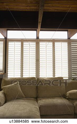 Plantation shutters over sofa View Large Photo Image Stock Photography - Plantation shutters over sofa. Fotosearch