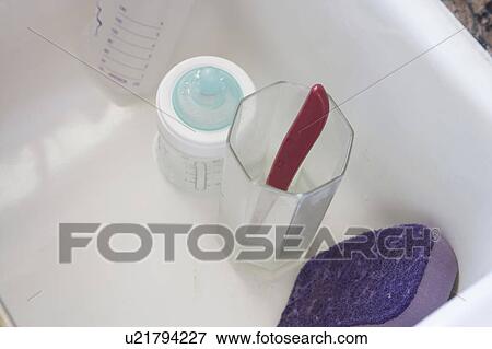 Detail of baby bottle and plastic up on a sink, close up View Large Photo Image Stock Photo - Detail of baby bottle and plastic up on a sink, close up. Fotosearch