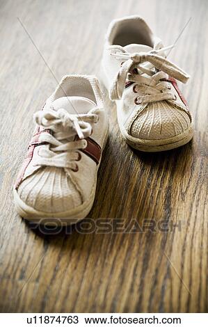 Detail of kids sneakers on hardwood floor View Large Photo Image Stock Image - Detail of kids sneakers on hardwood floor. Fotosearch