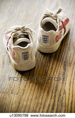 Detail of kids sneakers on hardwood floor View Large Photo Image Stock Photo - Detail of kids sneakers on hardwood floor. Fotosearch