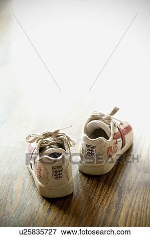 Detail of kids sneakers on hardwood floor View Large Photo Image Stock Photo - Detail of kids sneakers on hardwood floor. Fotosearch
