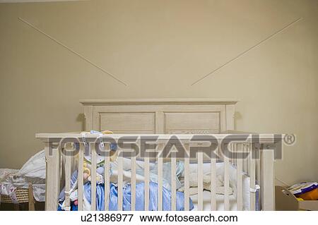 Interior of a baby room with a crib View Large Photo Image Stock Photo - Interior of a baby room with a crib. Fotosearch