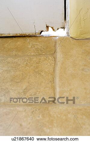 Stock Image - Mouse-hole in a door. Fotosearch