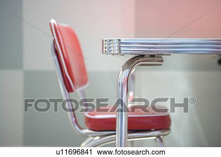 Stock Image - Detail of a red and chrome Retro Style childrens table with chair. Fotosearch