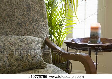 Stock Photograph - Detail of Armchair and Candle. Fotosearch