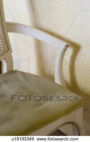 Stock Photo - Detail of worn chair with cushion.. Fotosearch
