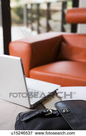 Laptop And Modern Orange Leather Armchair Stock Photo U15246537