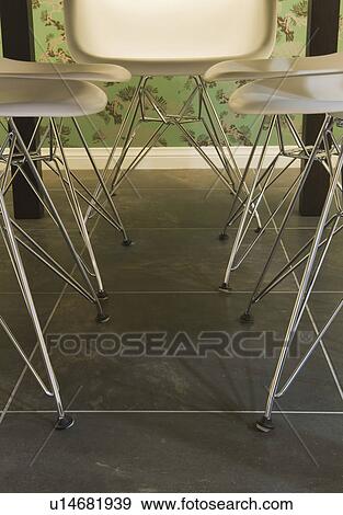 Stock Photo - Modern dining chairs and green wallpaper. Fotosearch