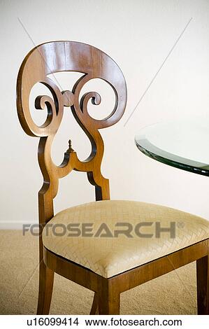 Ornate Wood Chair at Glass Table View Large Photo Image Picture - Ornate Wood Chair at Glass Table. Fotosearch