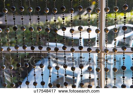 Bead curtains in front of window View Large Photo Image Stock Photo - Bead curtains in front of window. Fotosearch