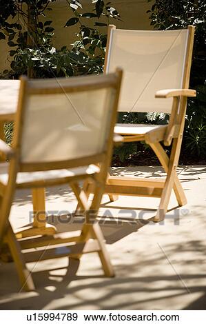 Canvas chairs in outdoor dining set View Large Photo Image Stock Photo - Canvas chairs in outdoor dining set. Fotosearch