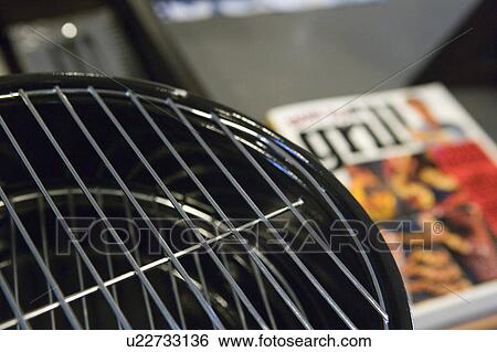 Detail of charcoal grill with cookbook in the background View Large Photo Image Stock Photograph - Detail of charcoal grill with cookbook in the background. Fotosearch