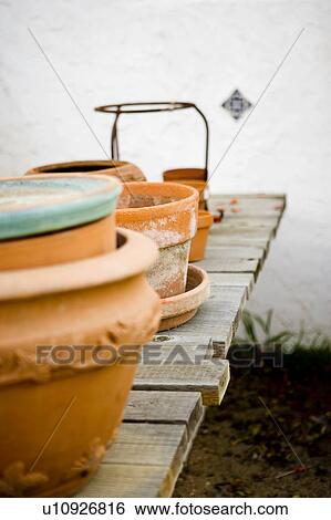 Empty terra cotta pots on wood deck View Large Photo Image Stock Photograph - Empty terra cotta pots on wood deck. Fotosearch