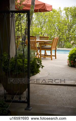 Stock Image - View down path to sitting area beside pool. Fotosearch
