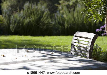 Stock Photo - Wooden outdoor dining table and chairs. Fotosearch