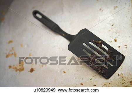 Detail of a dirty spatula on a dirty baking sheet View Large Photo Image Stock Photo - Detail of a dirty spatula on a dirty baking sheet. Fotosearch