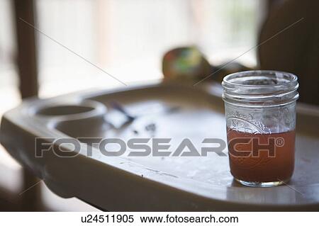 Dirty high chair tray with a glass of pink lemonade View Large Photo Image Stock Photography - Dirty high chair tray with a glass of pink lemonade. Fotosearch
