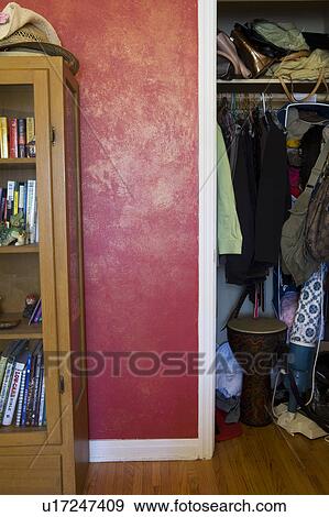 Stock Photo - Cluttered storage closet and bookcase.. Fotosearch