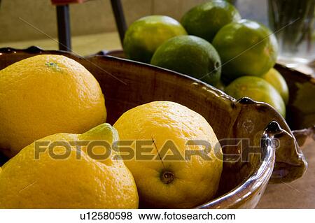 Stock Photo - Detail of bowls with lemons and limes.. Fotosearch