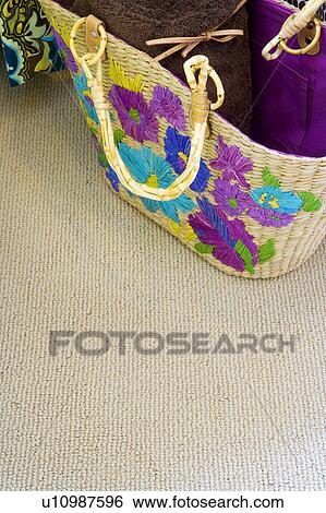 Stock Photograph - Detail of colorful handbag with items inside.. Fotosearch