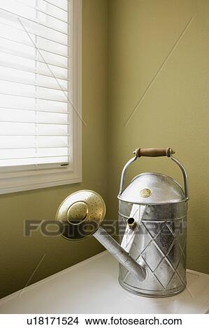 Picture - Detail of tin watering canister.. Fotosearch